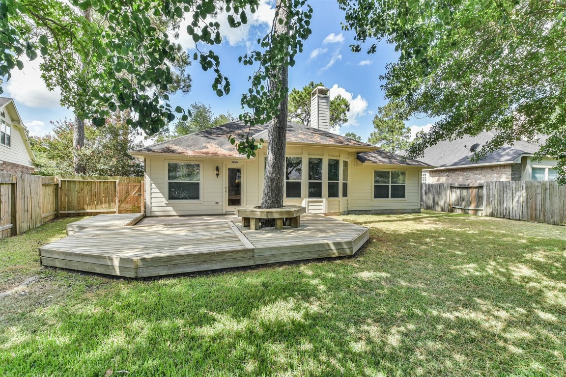 12711 Big Spring Trail Humble, TX 77346 - Photo 24 of 25 a backyard of a house with table and sofas
