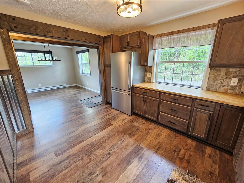 138 Center Drive Chicora, PA 16025 - Photo 11 of 25 a kitchen with stainless steel appliances granite countertop a refrigerator a sink dishwasher and wooden floor