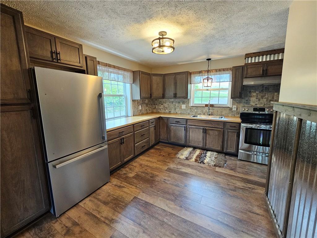 138 Center Drive Chicora, PA 16025 - Photo 12 of 25 a kitchen with stainless steel appliances granite countertop a refrigerator and a stove