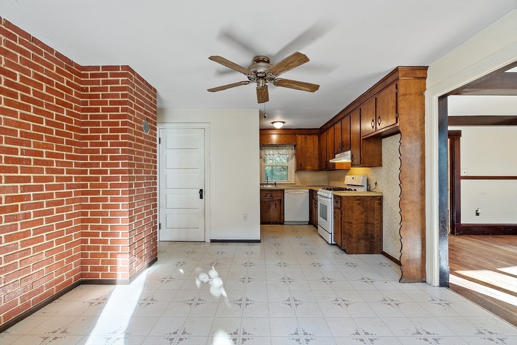 18 Middlesex Road Tyngsboro, MA 01879 - Photo 5 of 41 a view of a kitchen with a sink and a refrigerator