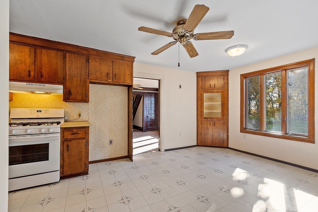 18 Middlesex Road Tyngsboro, MA 01879 - Photo 8 of 41 a view of a kitchen with a stove cabinets and a kitchen