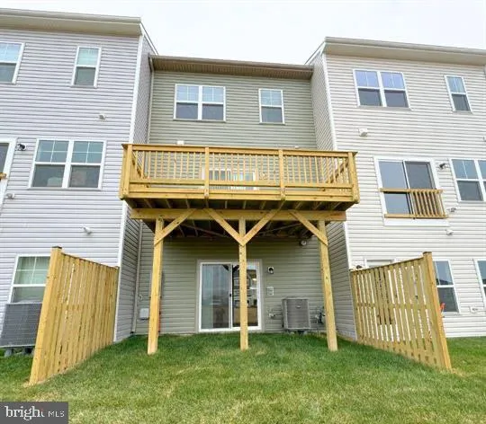 a view of a house with wooden fence