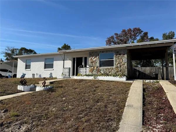 a view of a house with backyard porch and sitting area