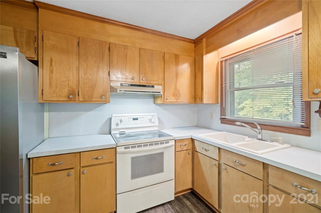1912 Normandy Road Kannapolis, NC 28081 - Photo 11 of 43 a kitchen with stainless steel appliances white cabinets and a sink