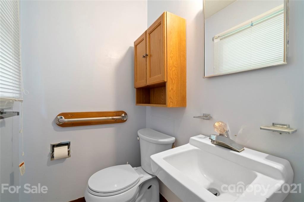 1912 Normandy Road Kannapolis, NC 28081 - Photo 15 of 43 a bathroom with a sink a toilet and mirror