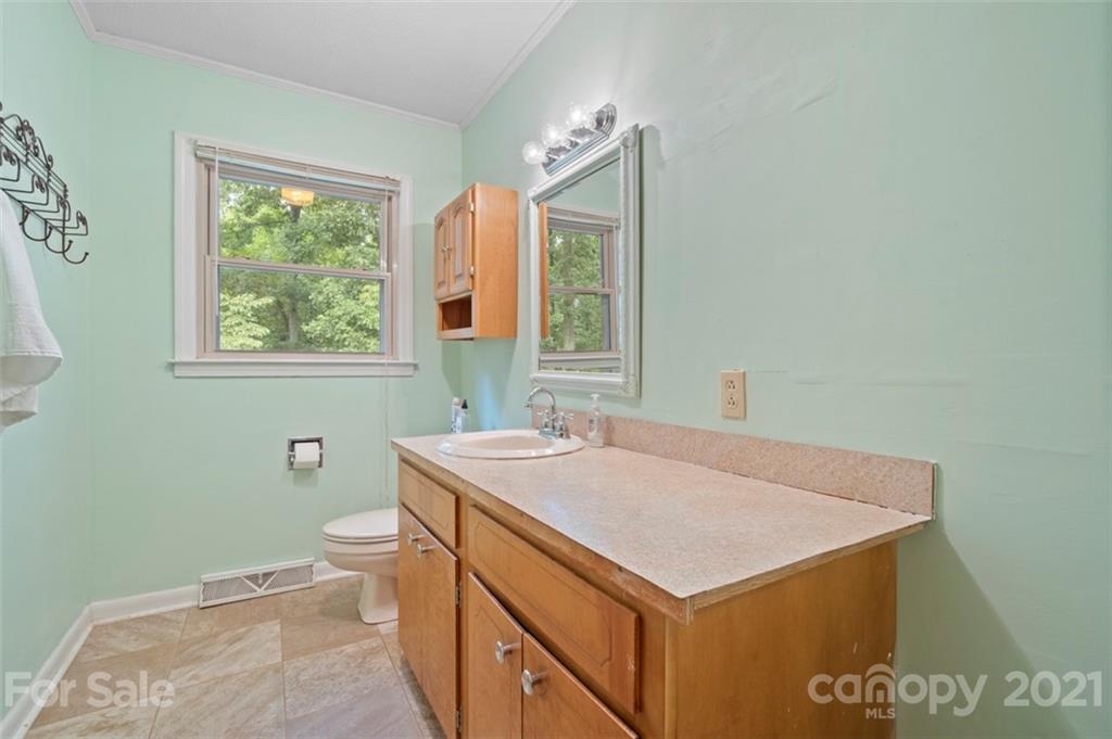 1912 Normandy Road Kannapolis, NC 28081 - Photo 22 of 43 a bathroom with a sink a toilet and a window