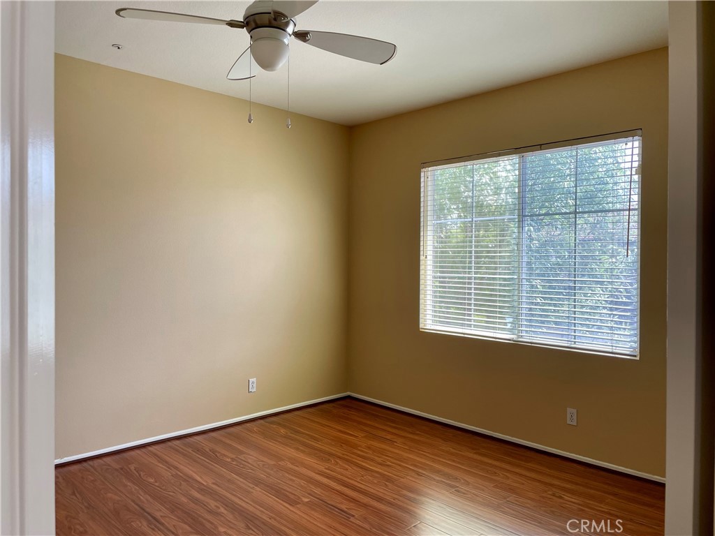 149 Islington Irvine, CA 92620 - Photo 12 of 15 a view of an empty room with a window and wooden floor