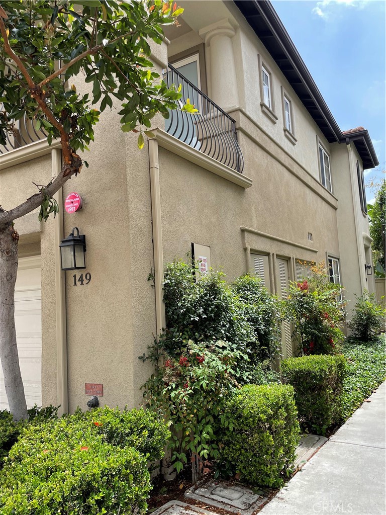149 Islington Irvine, CA 92620 - Photo 2 of 15 a front view of a house with garage and plants