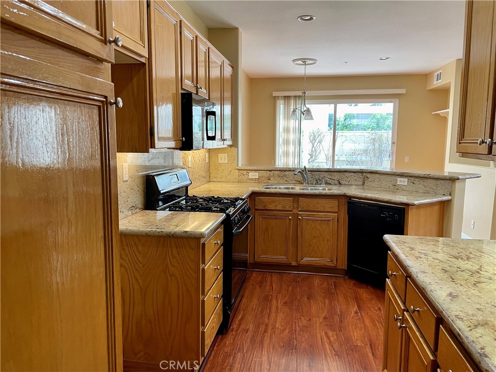 149 Islington Irvine, CA 92620 - Photo 8 of 15 a kitchen with a sink stove and cabinets