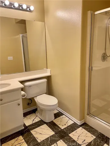a bathroom with a toilet and a shower