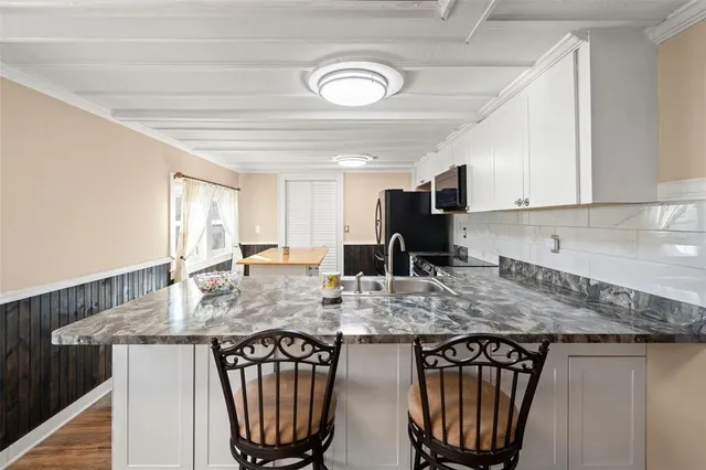a view of kitchen and dining area with wooden floor