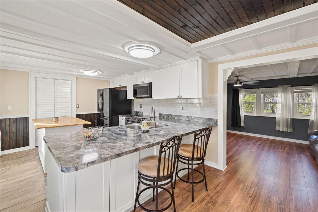 7288 Coventry Court Weeki Wachee, FL 34607 - Photo 12 of 82 a view of kitchen and dining area with wooden floor
