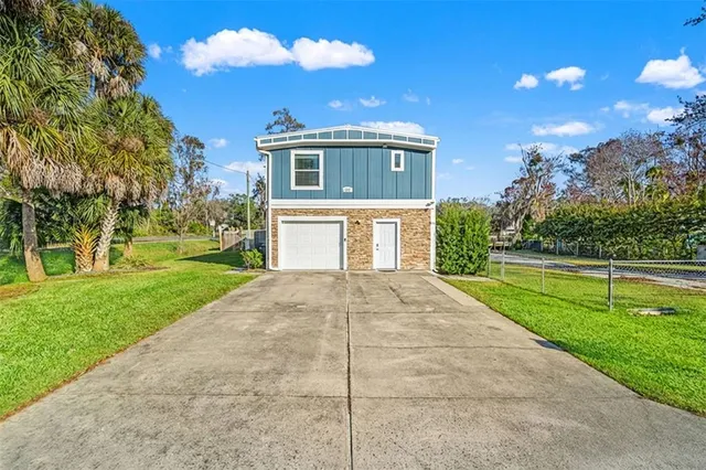 a front view of house with yard and green space