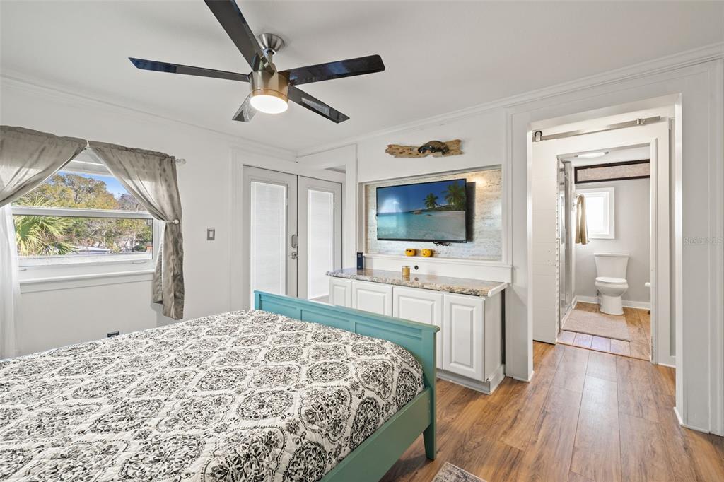 7288 Coventry Court Weeki Wachee, FL 34607 - Photo 24 of 82 a bedroom with a bed and a flat screen tv