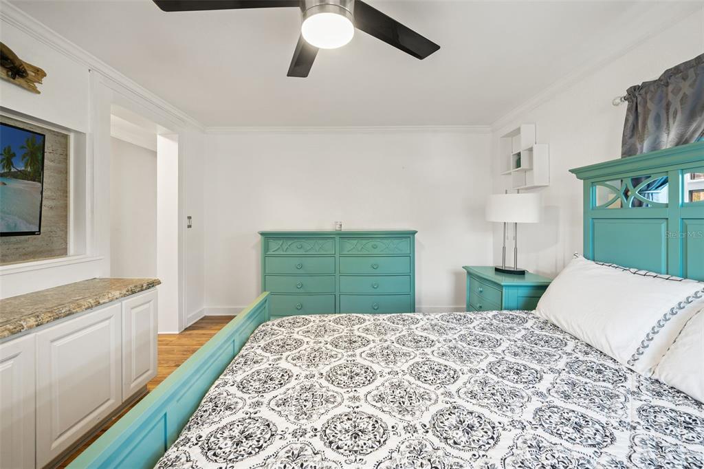 7288 Coventry Court Weeki Wachee, FL 34607 - Photo 25 of 82 a bedroom with a bed and a dresser with rug