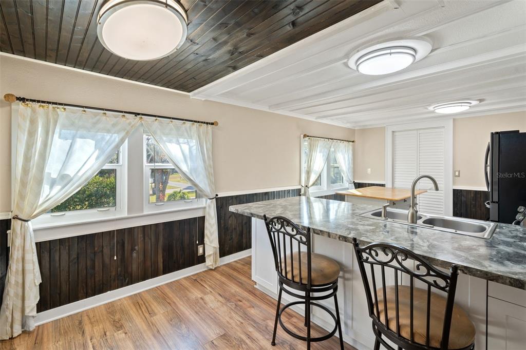 7288 Coventry Court Weeki Wachee, FL 34607 - Photo 32 of 82 a kitchen with stainless steel appliances granite countertop a stove a sink a dining table and chairs