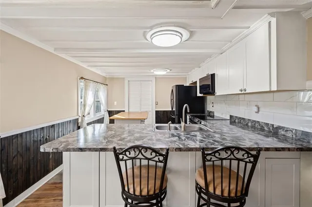 a view of a house with a wooden deck