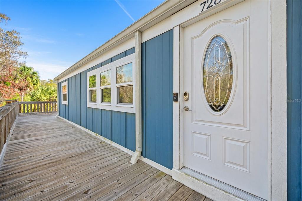 7288 Coventry Court Weeki Wachee, FL 34607 - Photo 41 of 82 a view of a house with a wooden door and a window