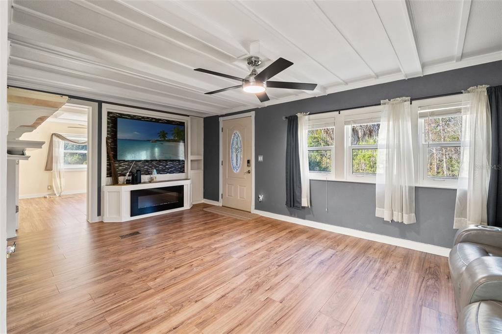 7288 Coventry Court Weeki Wachee, FL 34607 - Photo 5 of 82 a view of an empty room with window and wooden floor