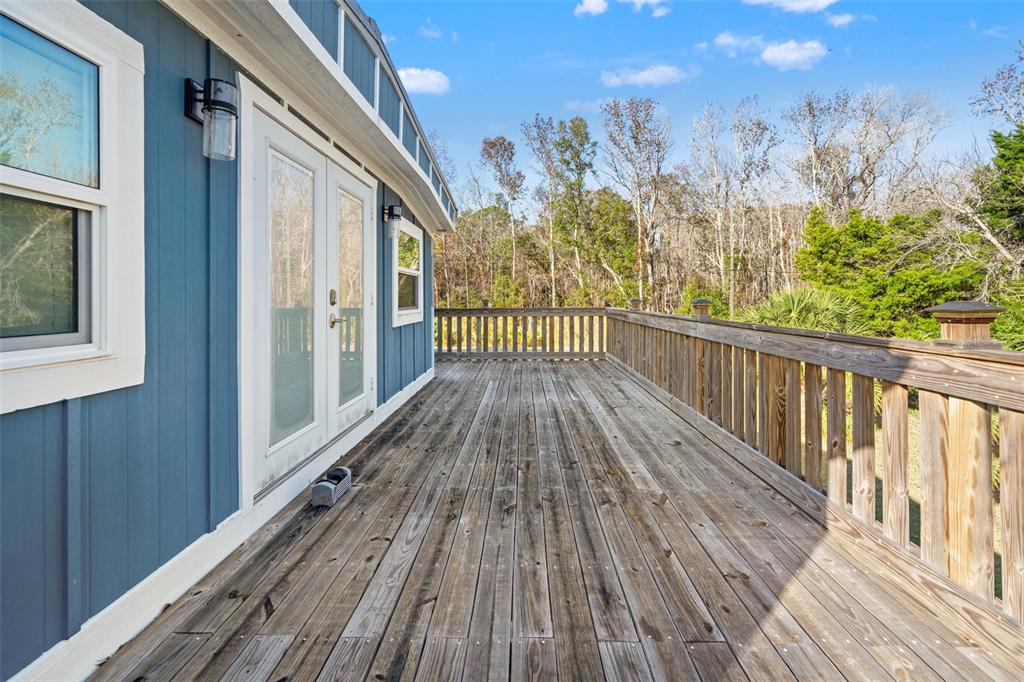 7288 Coventry Court Weeki Wachee, FL 34607 - Photo 51 of 82 a view of a balcony with wooden floor and fence