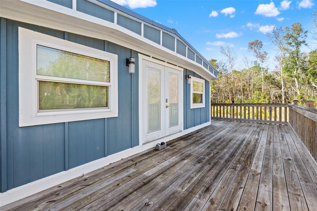 7288 Coventry Court Weeki Wachee, FL 34607 - Photo 52 of 82 a view of a house with a wooden deck
