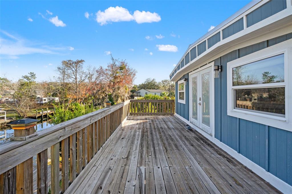 7288 Coventry Court Weeki Wachee, FL 34607 - Photo 54 of 82 a view of a balcony with wooden floor