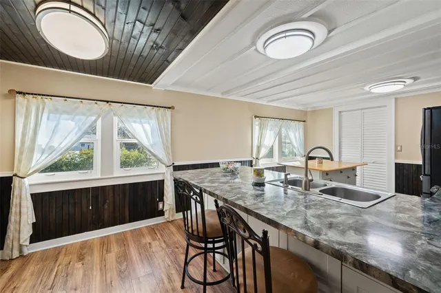 a kitchen with stainless steel appliances granite countertop a stove a sink dishwasher a microwave oven with granite countertops and cabinets