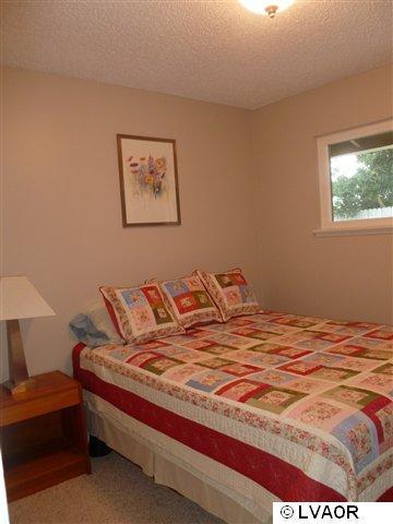 3976 Constellation Road Lompoc, CA 93436 - Photo 2 of 9 a bedroom with a bed and a lamp on dresser