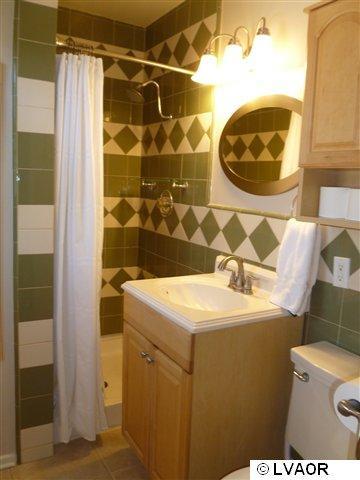 3976 Constellation Road Lompoc, CA 93436 - Photo 3 of 9 a bathroom with a sink toilet and shower