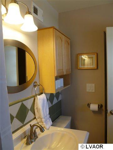3976 Constellation Road Lompoc, CA 93436 - Photo 4 of 9 a bathroom with a mirror and a sink
