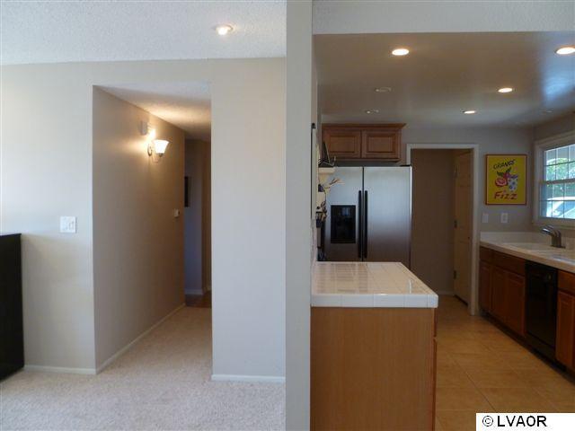 3976 Constellation Road Lompoc, CA 93436 - Photo 6 of 9 a kitchen with stainless steel appliances a refrigerator and a sink