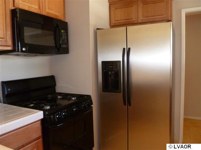 3976 Constellation Road Lompoc, CA 93436 - Photo 9 of 9 a kitchen with a refrigerator and a microwave