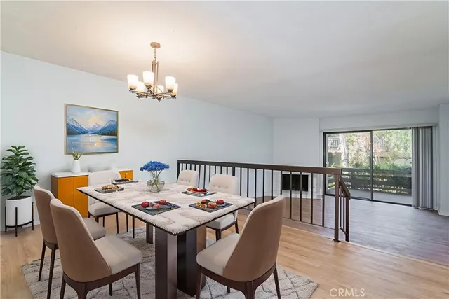 a view of a dining room with furniture wooden floor and chandelier