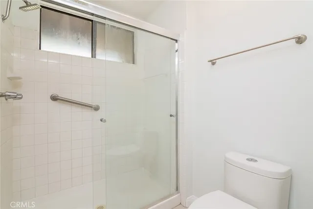 a bathroom with a toilet and a shower