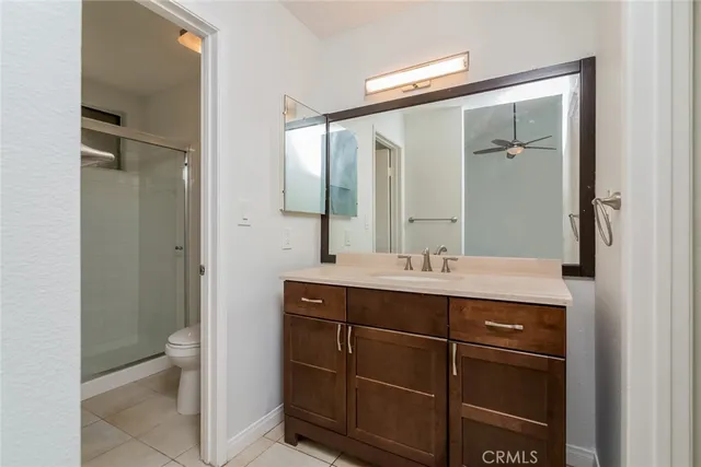 a bathroom with a double vanity sink toilet and a mirror