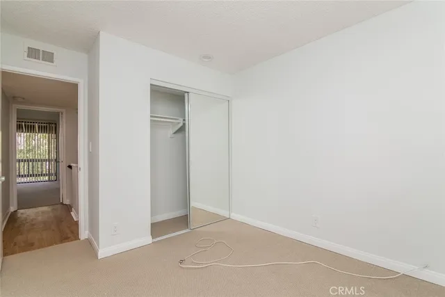 a view of an empty room and closet