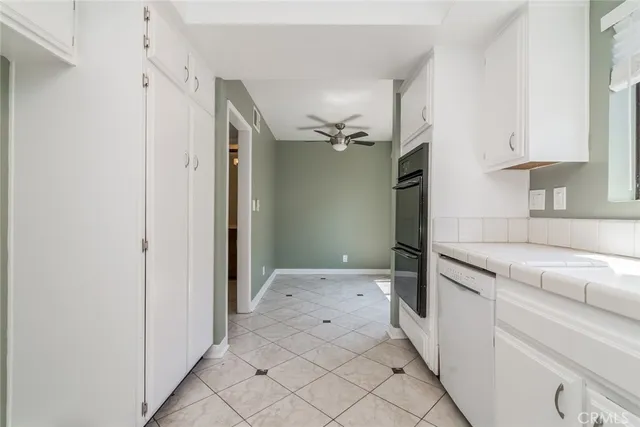 a view of a kitchen with white cabinets