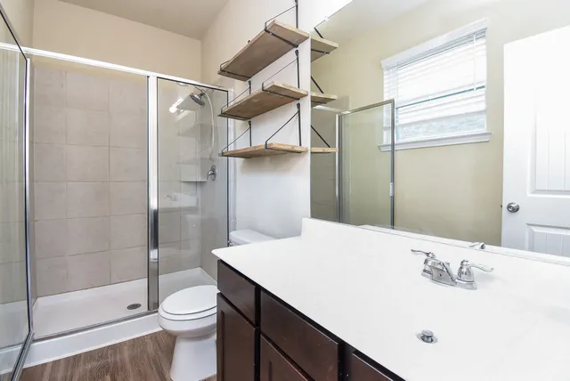 a bathroom with a sink toilet and shower