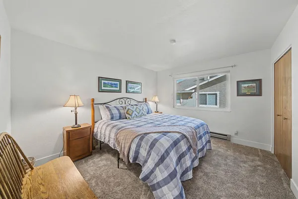 a bed room with a bed and a window