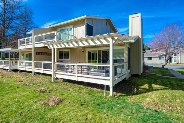 a front view of a house with a yard and plants
