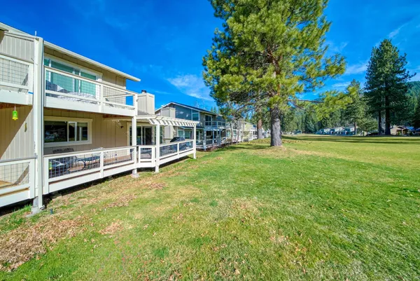 a view of a swimming pool with a bench and trees