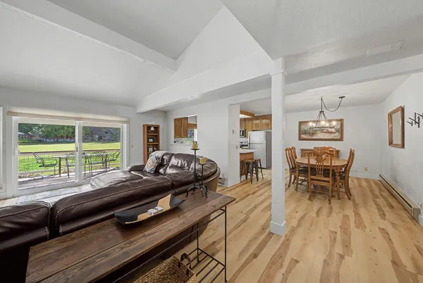 a view of a dining room with furniture and wooden floor
