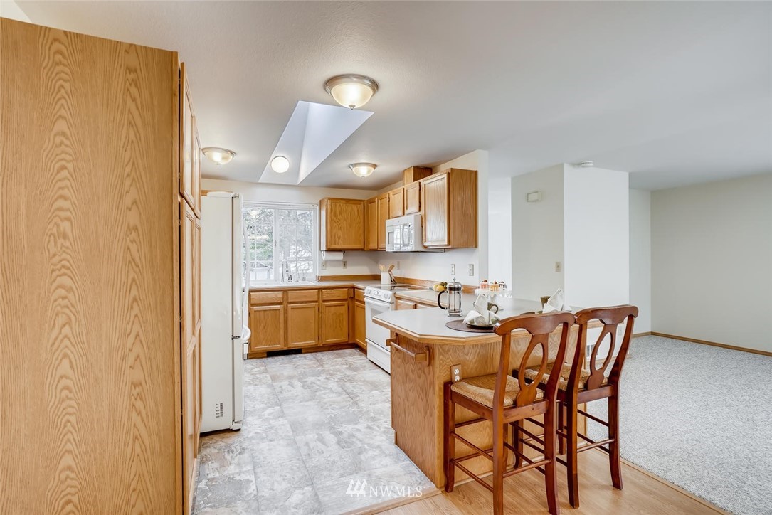 22007 4th Avenue Southeast Bothell, WA 98021 - Photo 5 of 22 a view of a dining room with furniture and a kitchen
