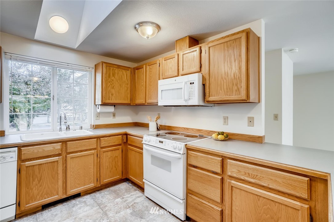 22007 4th Avenue Southeast Bothell, WA 98021 - Photo 6 of 22 a kitchen with stainless steel appliances granite countertop a sink a stove and cabinets