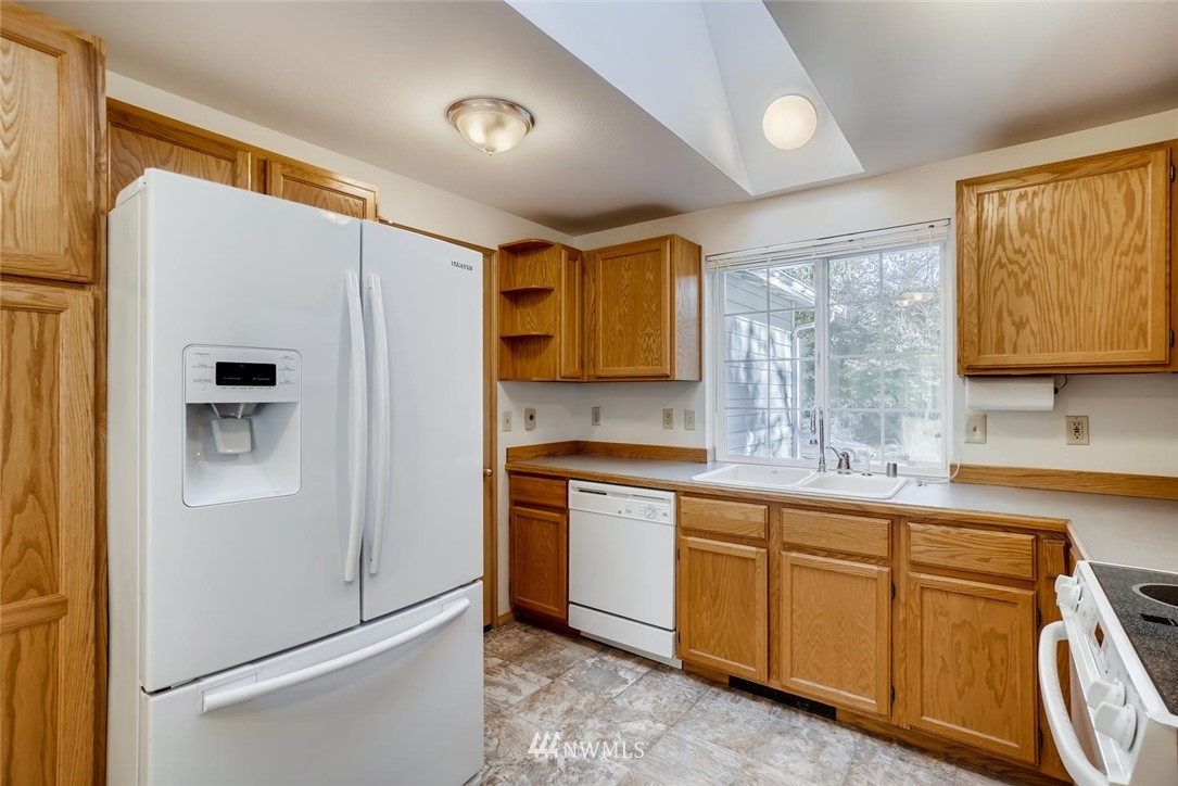 22007 4th Avenue Southeast Bothell, WA 98021 - Photo 7 of 22 a kitchen with stainless steel appliances granite countertop a refrigerator and a sink