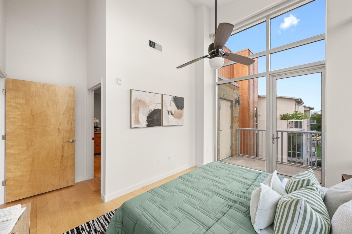 1600 Barton Springs Road, Unit 5601 Austin, TX 78704 - Photo 16 of 36 a bedroom with a bed and glass door
