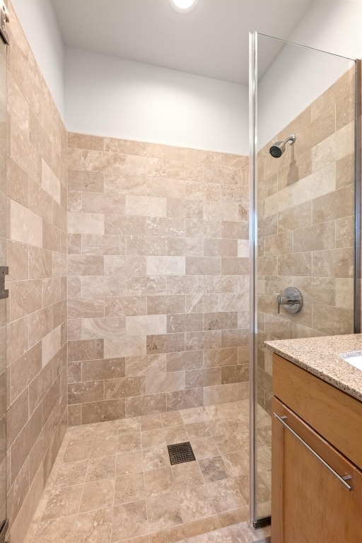 1600 Barton Springs Road, Unit 5601 Austin, TX 78704 - Photo 21 of 36 a bathroom with a granite countertop shower a sink and a shower