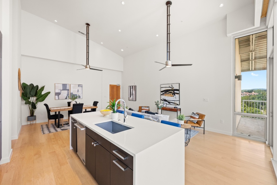 1600 Barton Springs Road, Unit 5601 Austin, TX 78704 - Photo 10 of 36 a kitchen that has a lot of cabinets couches and wooden floor