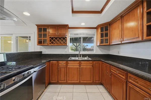 a kitchen with stainless steel appliances granite countertop a stove sink and cabinets