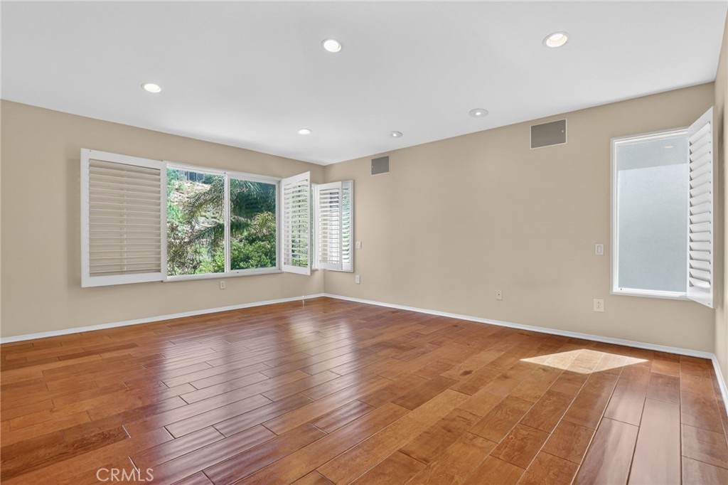 20543 Pesaro Porter Ranch Porter Ranch, CA 91326 - Photo 31 of 67 a view of an empty room with wooden floor and windows